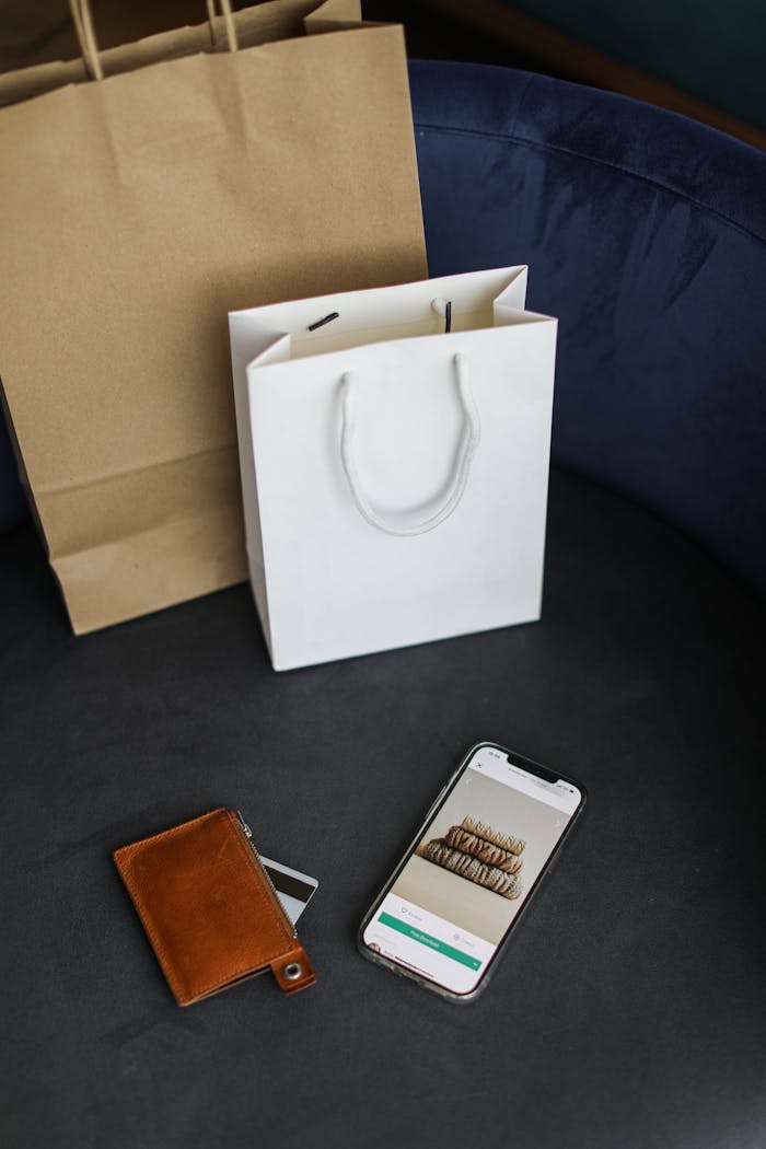 gallery-2 Modern online shopping setup with bags and smartphone.